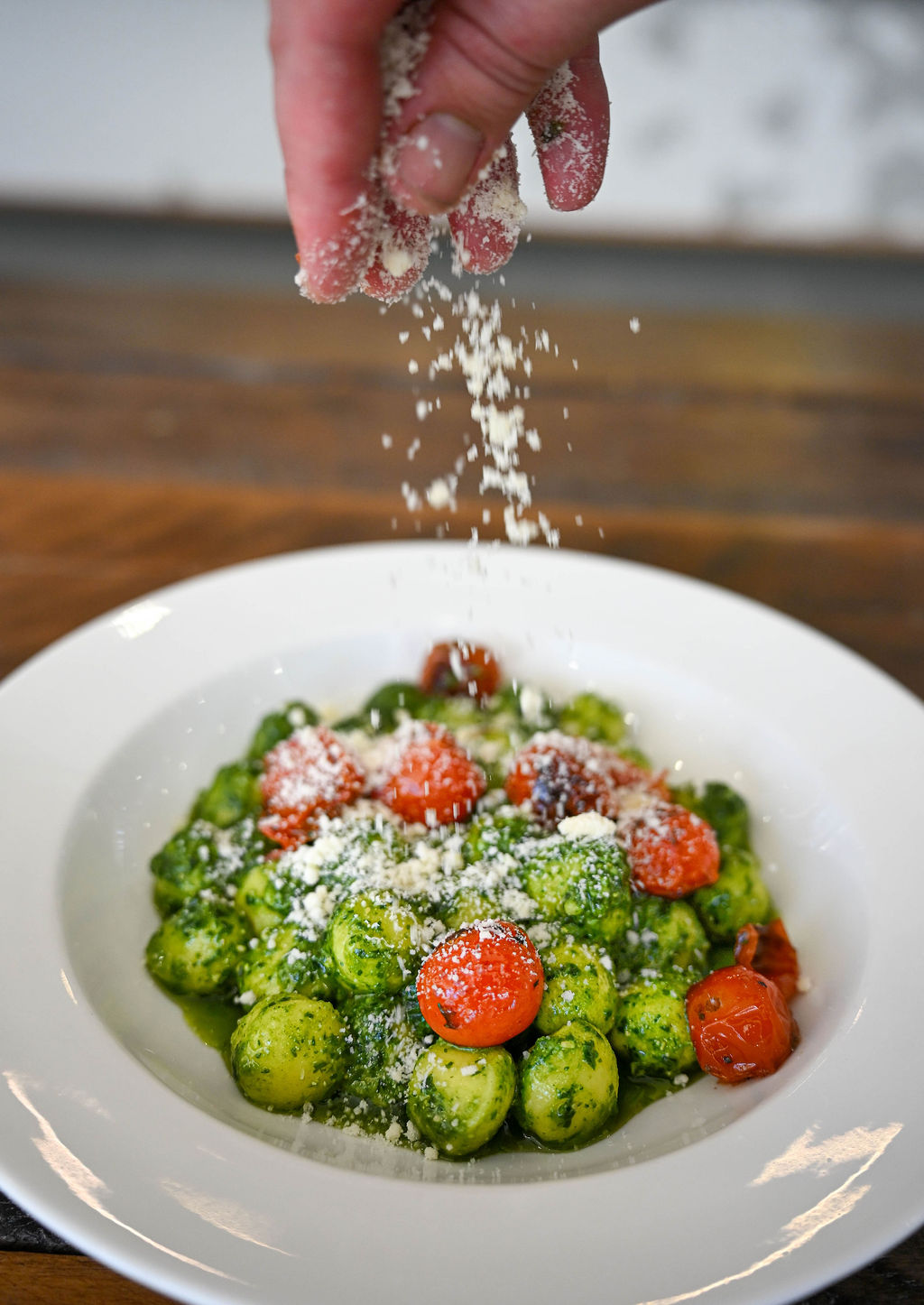 Pesto gnocchi with cherry tomatoes and parmesan