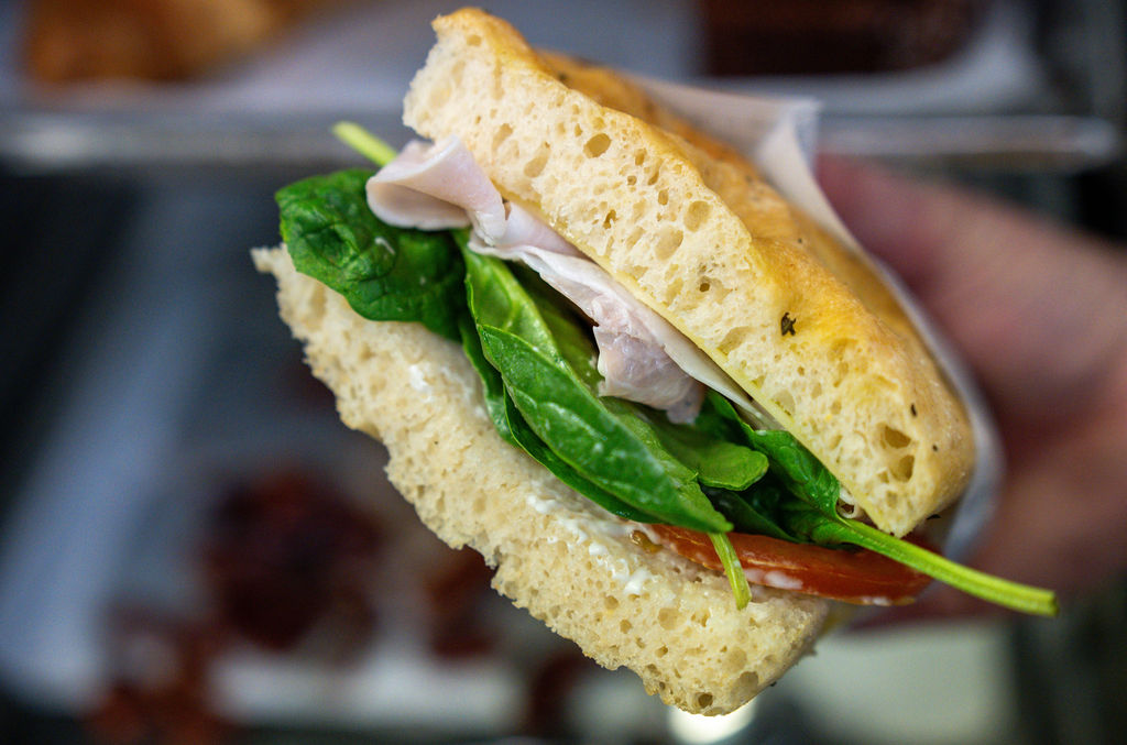 Fresh focaccia sandwich with mortadella and greens