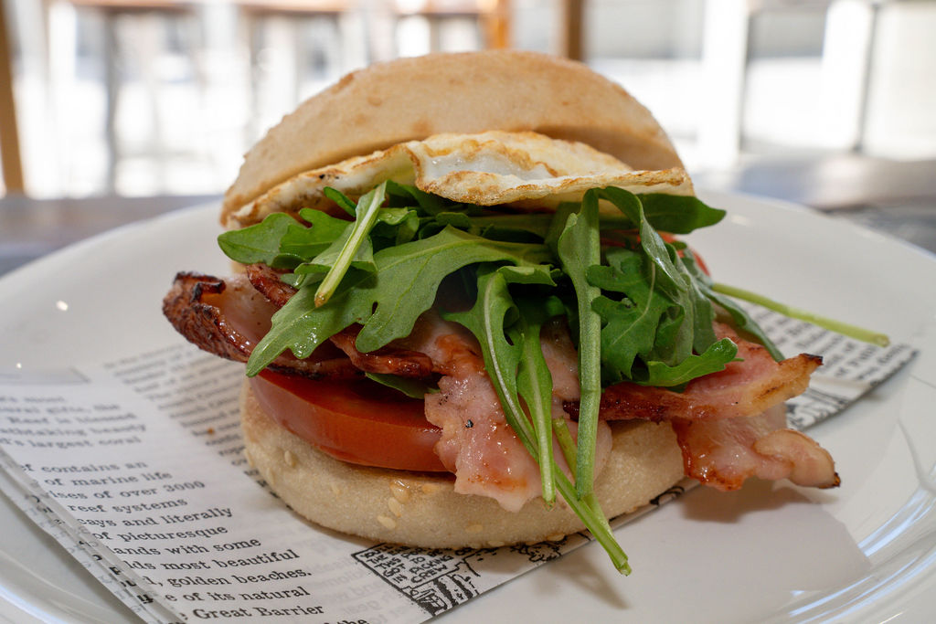 Bacon and egg roll with rocket and tomato