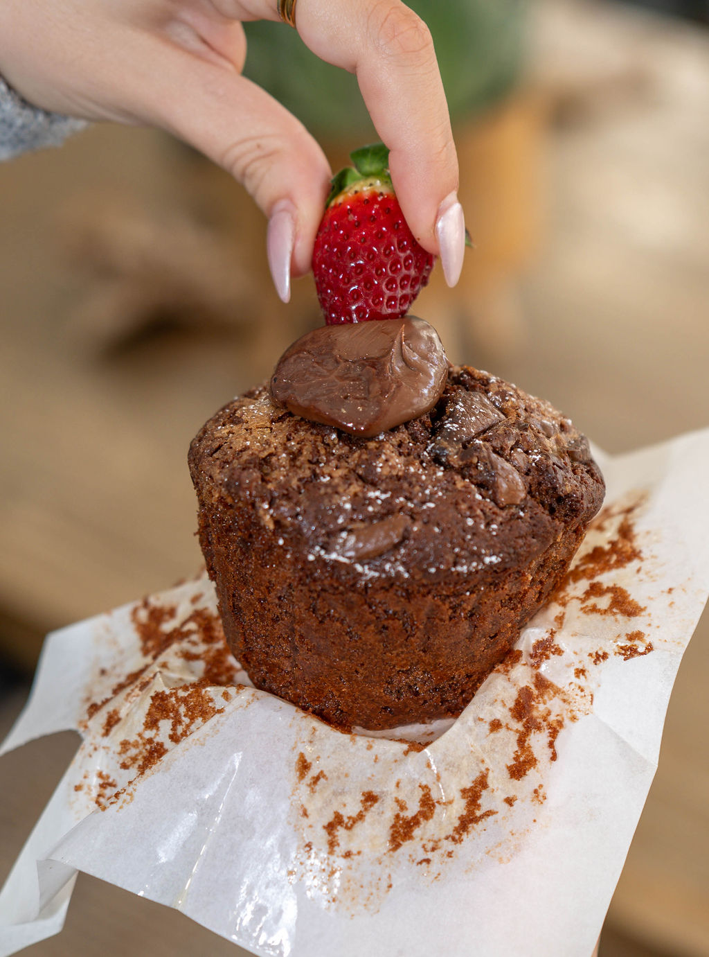 Chocolate muffin topped with a strawberry